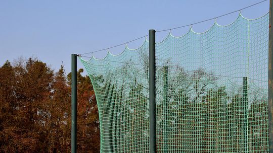 Jak dobrać wysokość piłkochwytu do boiska sportowego?